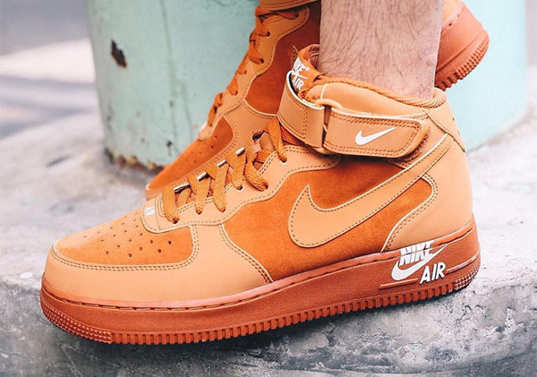 Nike Air Force 1 Mid 07 Orange Midsole Logo on feet