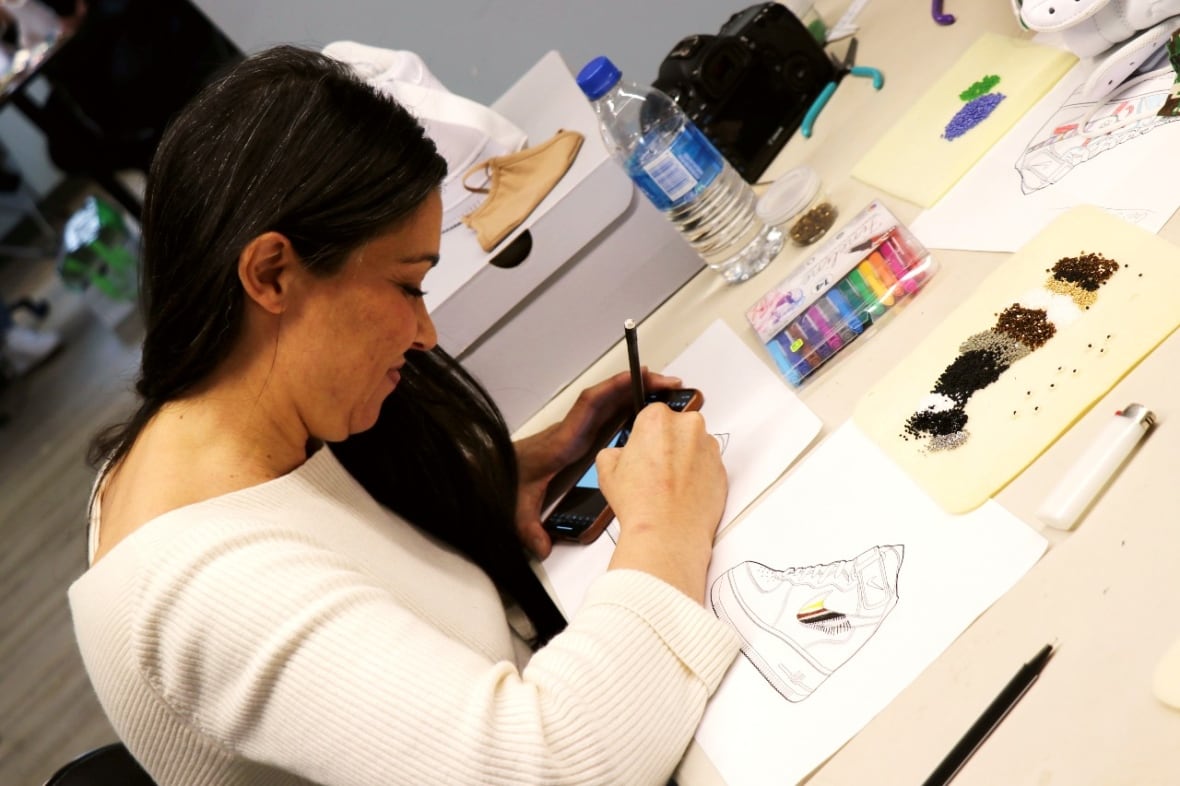 A workshop participant works on their sneaker design